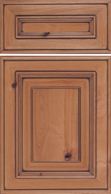 Eclipse Portland, A wooden cabinet door and drawer front with a natural finish, featuring raised panels and decorative edging. The wood grain and knots are visible, giving a rustic and classic appearance