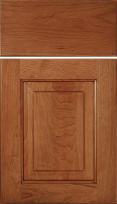 Eclipse Richmond, A wooden cabinet door and drawer front with a medium brown finish, displaying a recessed central panel and natural wood grain patterns