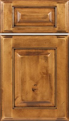 Eclipse Square Raised Panel, Close-up of a wooden cabinet door and drawer front with a medium brown finish, raised center panels, and visible wood grain patterns and knots. The design features beveled edges and a classic, traditional style