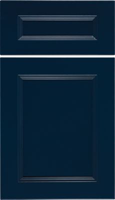 Eclipse Ward, A navy blue cabinet door and drawer front with a classic raised panel design and subtle decorative grooves around the edges