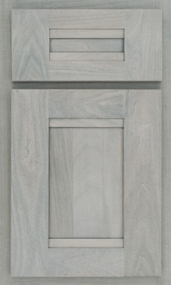Shiloh Bristol, A close-up of a light gray wooden cabinet door and drawer front from Bethesda Cabinets, featuring a modern, flat-panel design with visible wood grain patterns