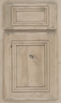 Shiloh Charleston, A cabinet door and drawer front made of light wood with a distressed finish, featuring raised rectangular panels and visible wood grain and knots