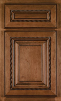 Shiloh Manchester, A wooden cabinet door with a raised panel design, featuring decorative molding and a rope-like carved trim around the inner edges. The warm, medium-brown finish adds classic appeal