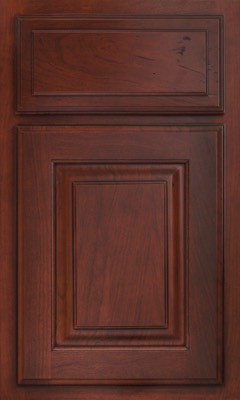 Shiloh Oxford Raised, A wooden cabinet door with a rich, dark brown finish from Bethesda Cabinets in Maryland, featuring raised rectangular panels and decorative molding. The visible wood grain adds texture and depth to the door’s classic design