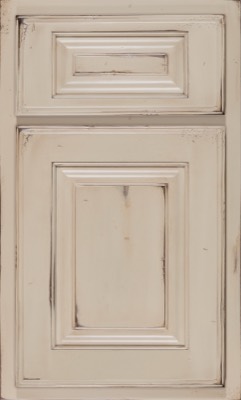 Shiloh Oxford, A distressed cream-colored cabinet door with raised panels and worn edges