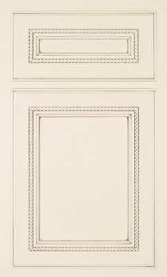 Shiloh Shelby, Cream-colored kitchen cabinet door with decorative rope-like trim outlining a rectangular raised panel and a smaller matching drawer panel above