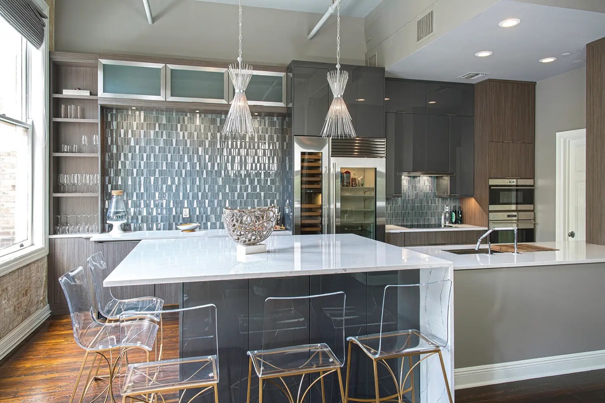 Modern kitchen by Bethesda Cabinets with frameless dark cabinets, a glass-tile backsplash, a waterfall island, and bar stools.