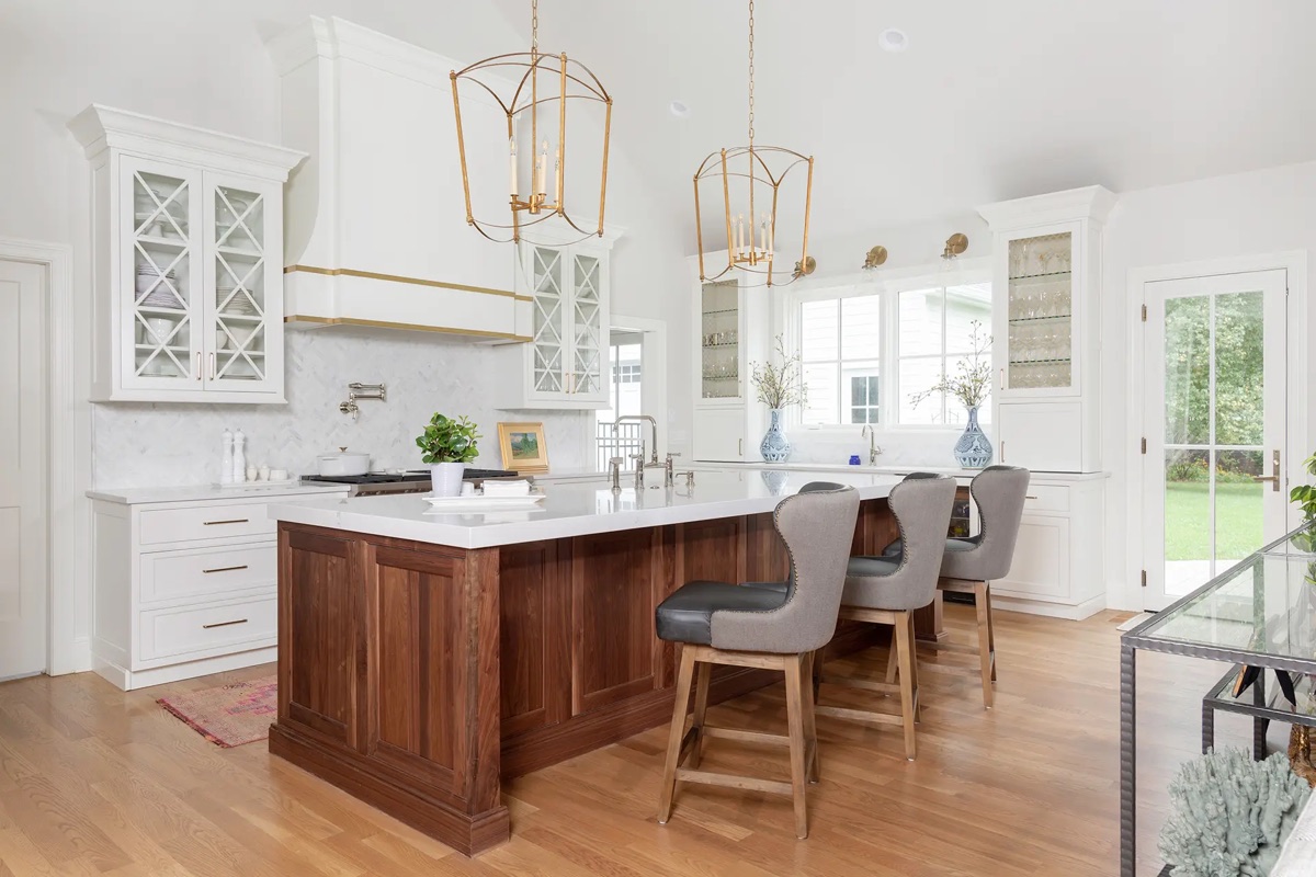 Kitchen by Bethesda Cabinets with inset white cabinets, a wood island, gold pendant lights, and an open-plan layout.