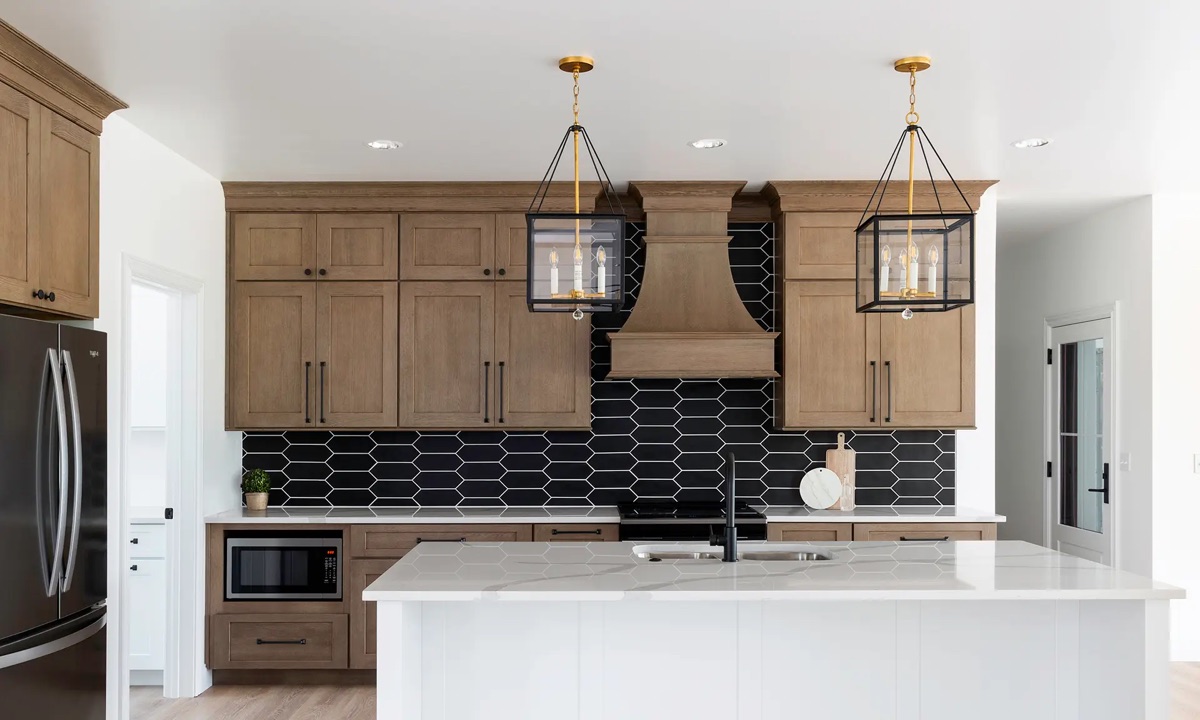 Modern Maryland kitchen by Bethesda Cabinets with gray-green cabinets, a wood range hood, a navy hexagon-tile backsplash, and a white island.