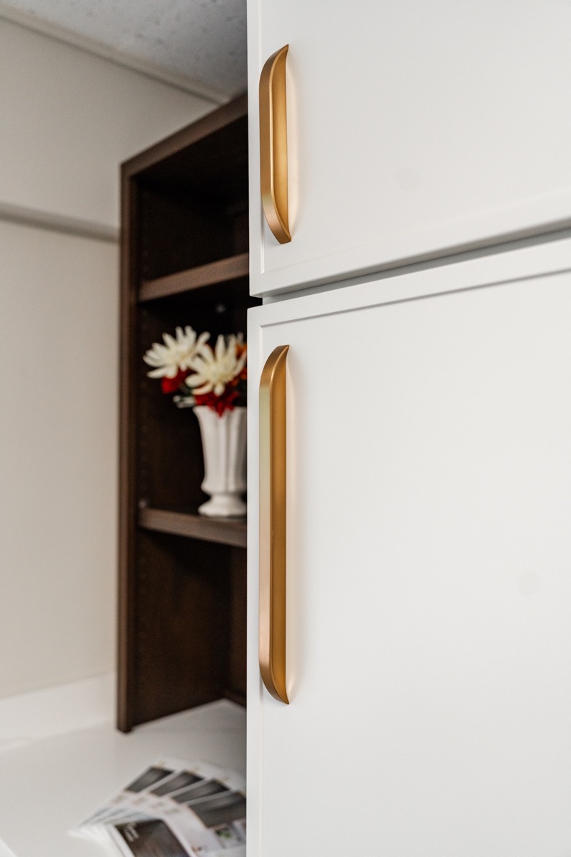Cabinet doors and drawers with brass hardware at the Bethesda Cabinets showroom in Bethesda, MD.