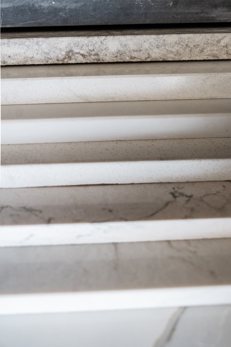 Countertop material samples at the Bethesda Cabinets showroom showing stacked marble and quartz slab edges.