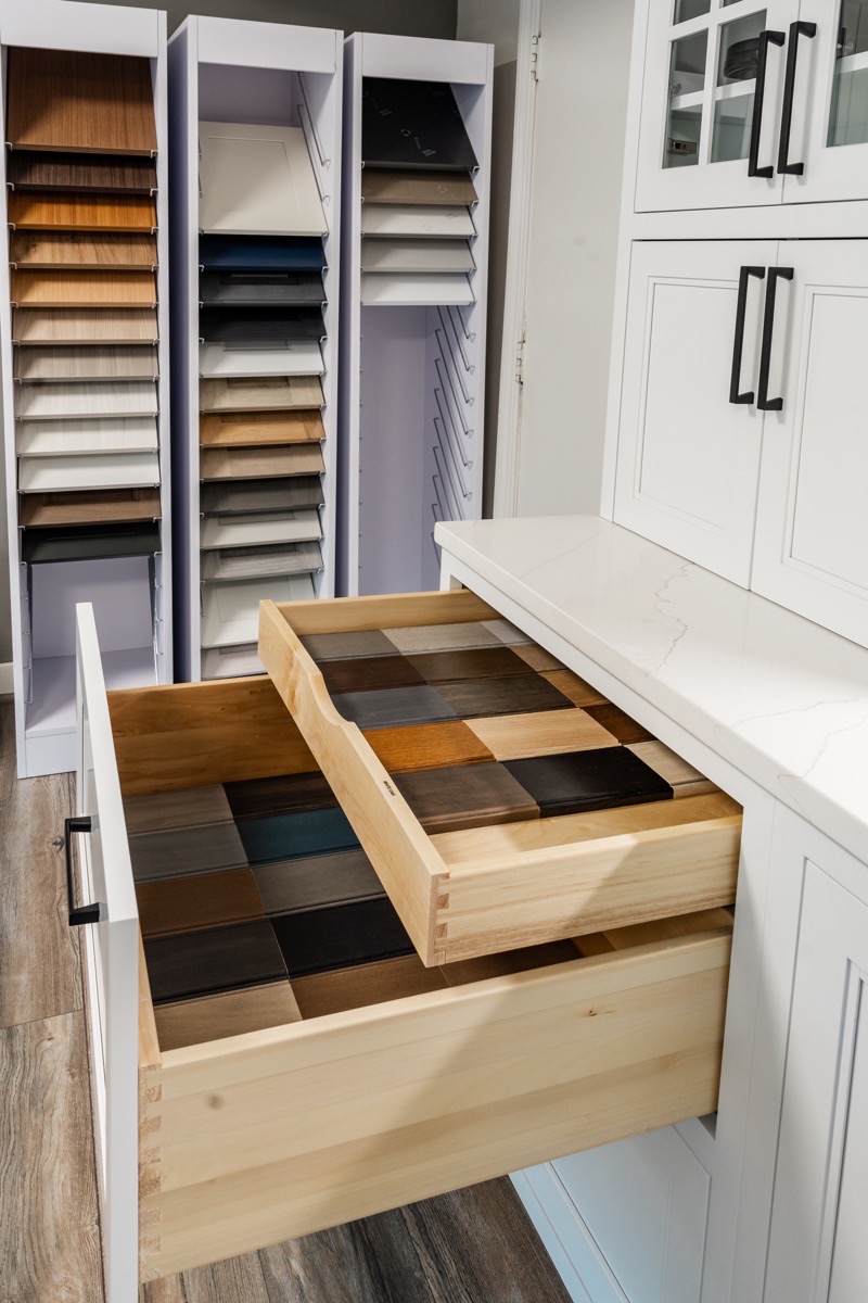 Selections display at the Bethesda Cabinets showroom with wood finish samples and a countertop sample drawer.
