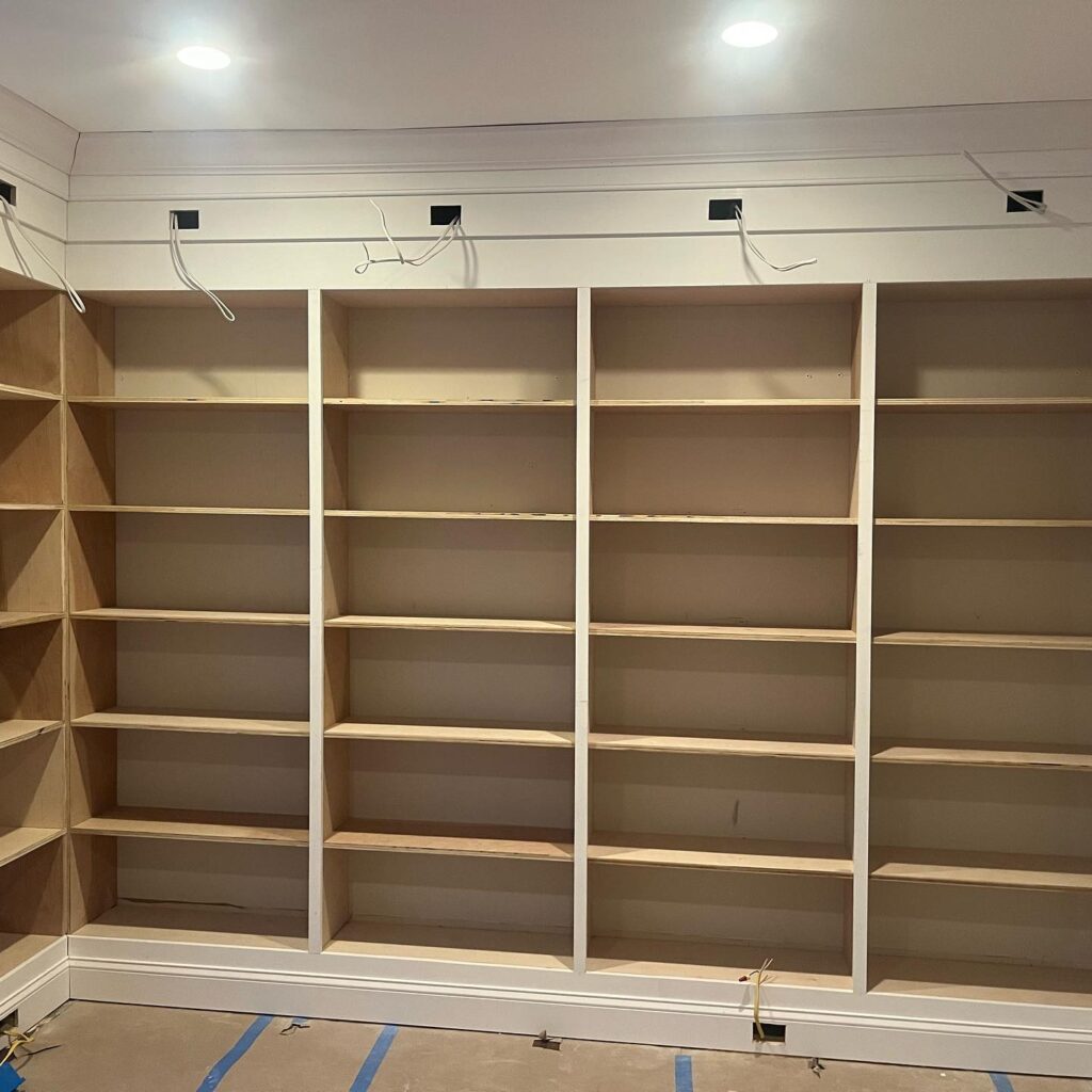 Custom cabinets for bookshelf in the living room by Bethesda Cabinets