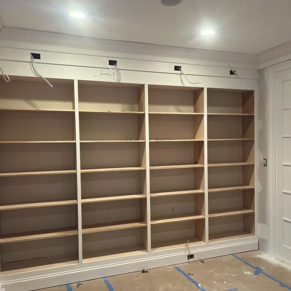 Custom cabinets for bookshelf in the living room by Bethesda Cabinets