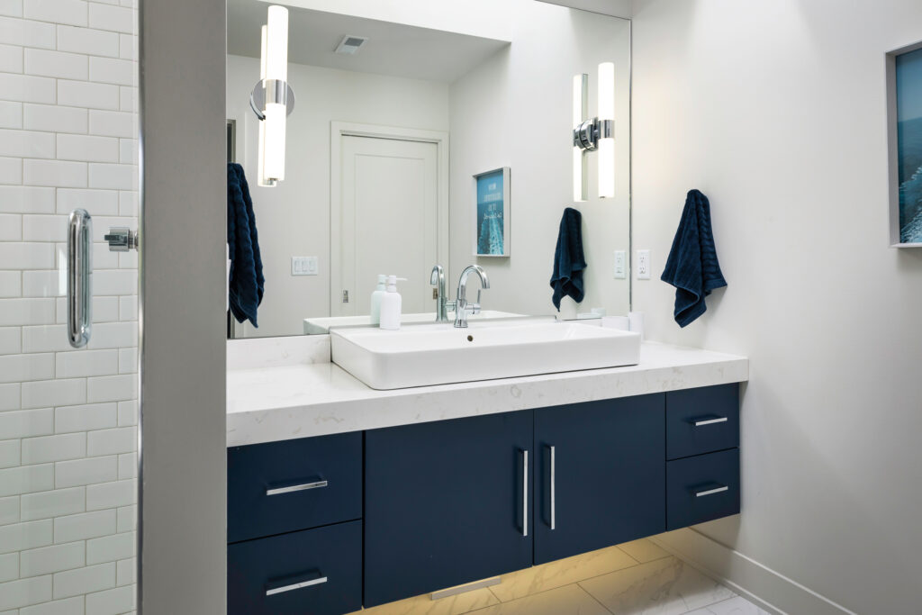A bathroom with a mirror and sink.